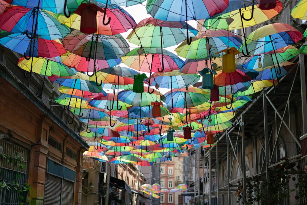 Background colorful rainbow different color umbrellas. unban tourist street decoration